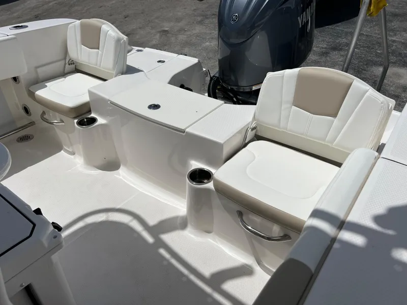Slide: The Image of 2025 Robalo R200 Center Console boat interior with seating and cup holders. - 13
