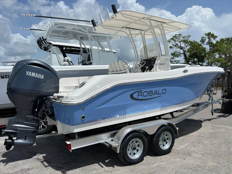 Slide: The Image of 2025 Robalo R200 Center Console boat on trailer with Yamaha outboard motor. - 2