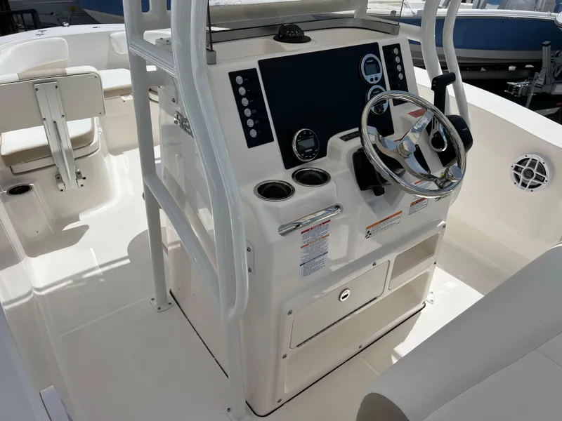 Slide: The Image of 2025 Robalo R200 Center Console boat interior with steering wheel and control panel. - 6