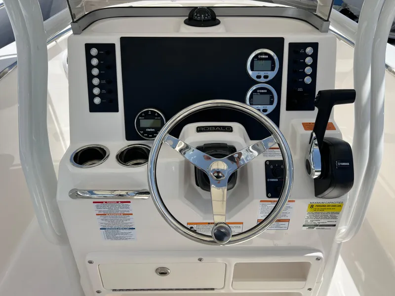 Slide: The Image of 2025 Robalo R200 Center Console boat dashboard with steering wheel and controls. - 7