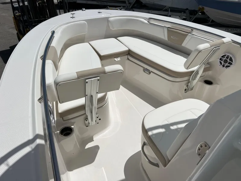 Slide: The Image of 2025 Robalo R200 Center Console boat interior with white seating and storage. - 8