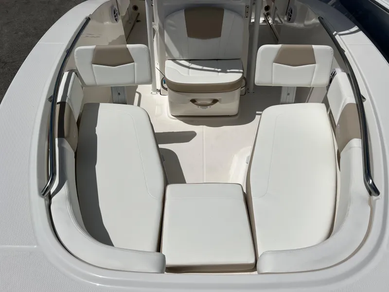 Slide: The Image of 2025 Robalo R200 Center Console boat interior with white cushioned seating. - 9