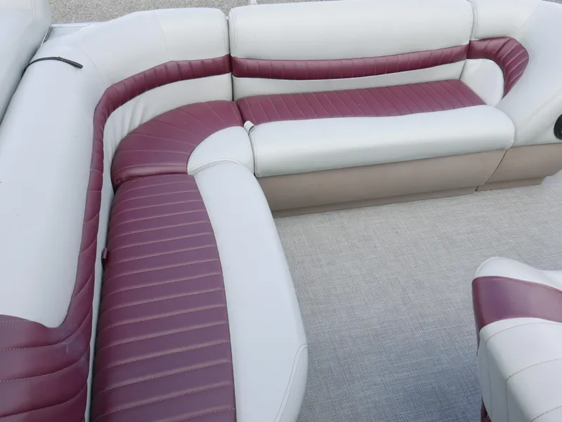 Slide: The Image of 2004 Tracker PB22OB boat interior with white and maroon seating. - 10