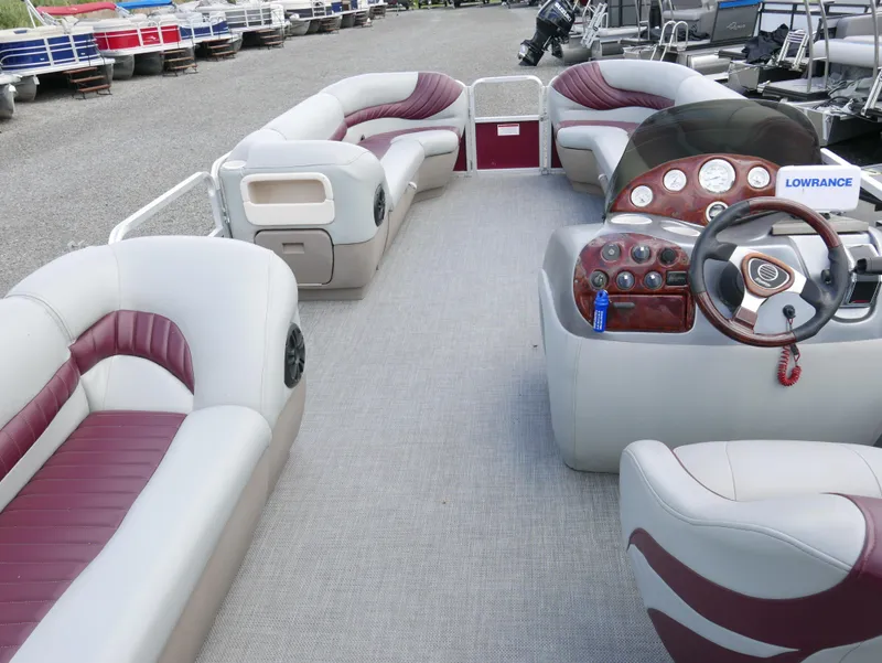 Slide: The Image of 2004 Tracker PB22OB pontoon boat interior with plush seating and control console. - 12