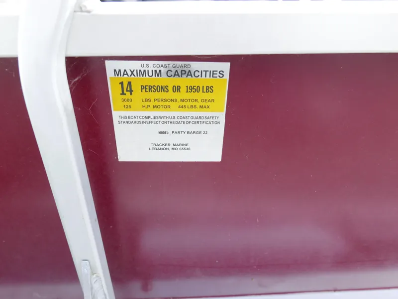 Slide: The Image of 2004 Tracker PB22OB boat capacity label, 14 persons or 1950 lbs, U.S. Coast Guard compliant. - 13