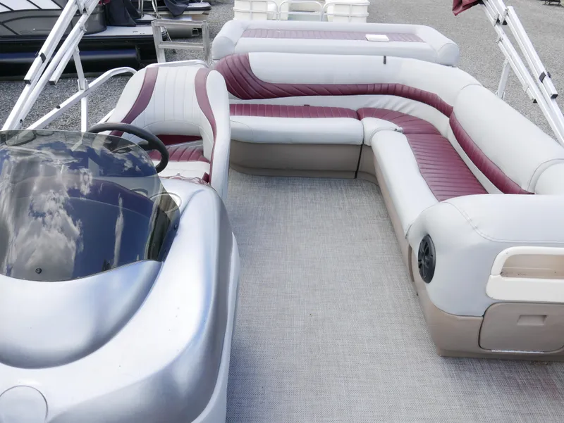 Slide: The Image of 2004 Tracker PB22OB pontoon boat interior with maroon and white seating. - 7