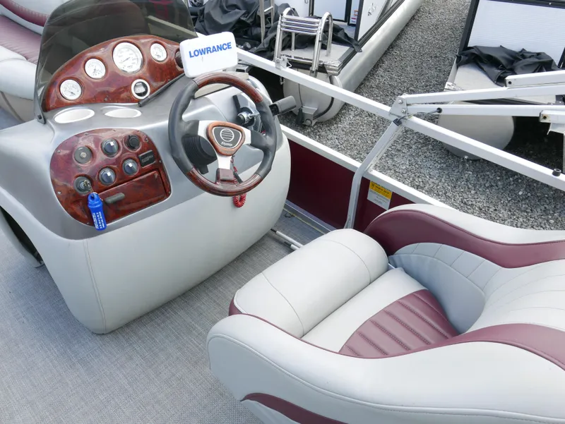 Slide: The Image of 2004 Tracker PB22OB boat dashboard and captain's chair with Lowrance electronics. - 8
