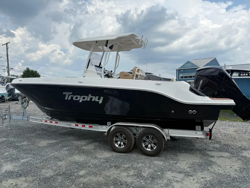 The Image of 2024 Bayliner Trophy T24CC boat on trailer under cloudy sky. - 18