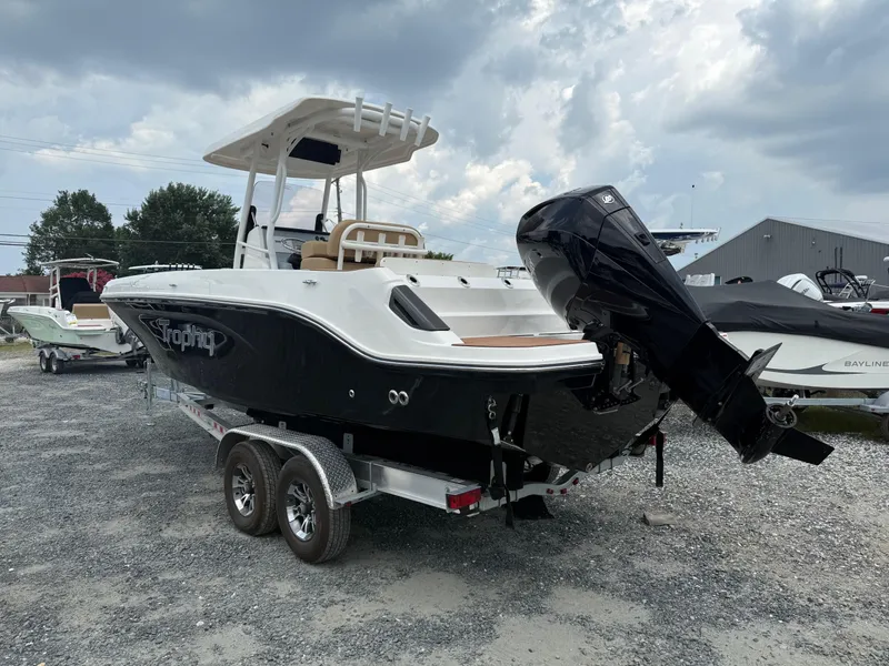 Slide: The Image of 2024 Bayliner Trophy T24CC boat on trailer, displayed outdoors under cloudy sky. - 20