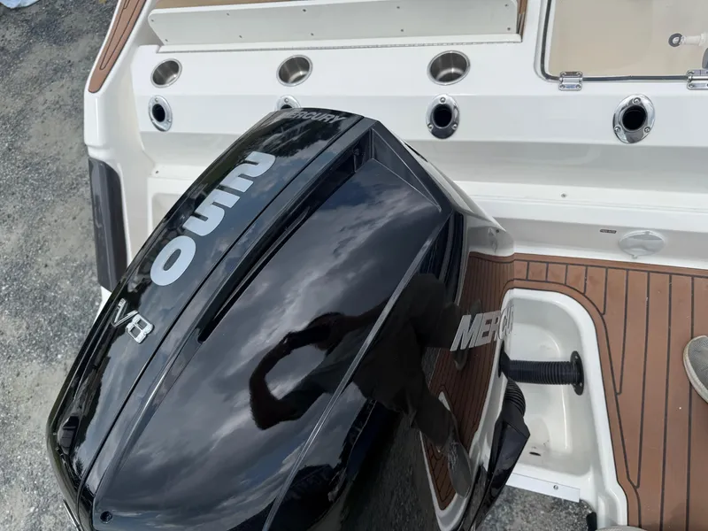 Slide: The Image of 2024 Bayliner Trophy T24CC with Mercury V8 outboard engine, rear deck view. - 24