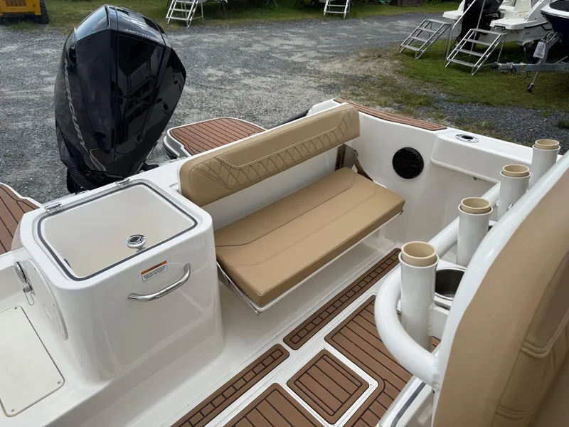 Slide: The Image of 2024 Bayliner Trophy T24CC boat interior with tan seating and rod holders. - 26
