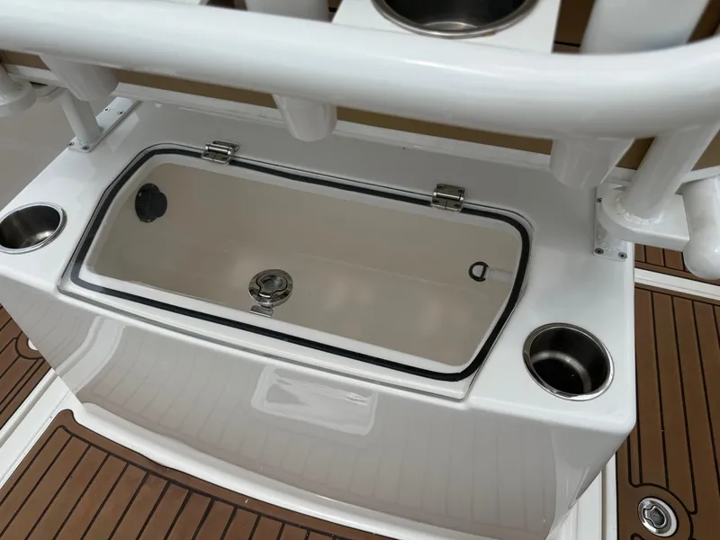 Slide: The Image of 2024 Bayliner Trophy T24CC livewell and cup holders on deck. - 30