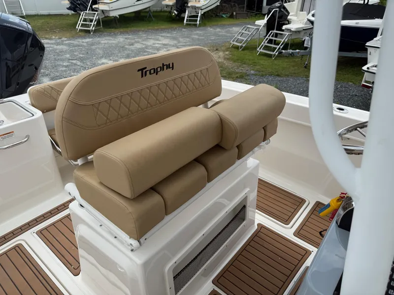 Slide: The Image of 2024 Bayliner Trophy T24CC boat interior with tan seating and wood-patterned flooring. - 31