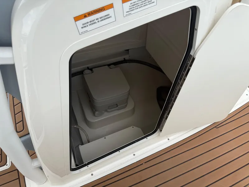 Slide: The Image of 2024 Bayliner Trophy T24CC boat interior with open storage compartment. - 35