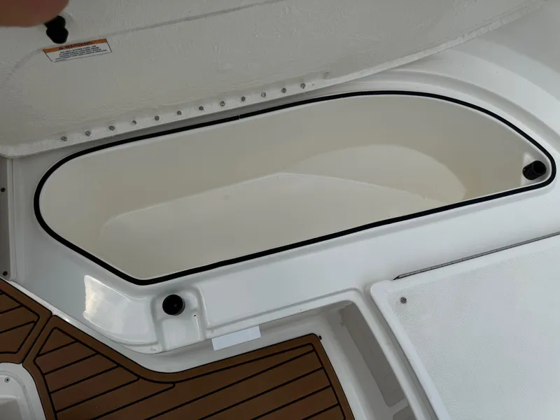 Slide: The Image of 2024 Bayliner Trophy T24CC storage compartment with teak-style flooring. - 39