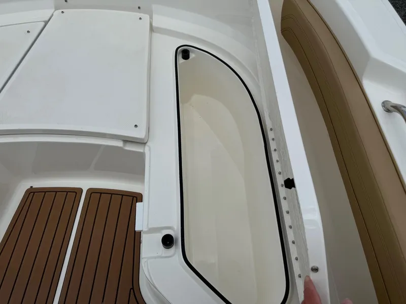 Slide: The Image of 2024 Bayliner Trophy T24CC boat interior with storage compartment and seating. - 40