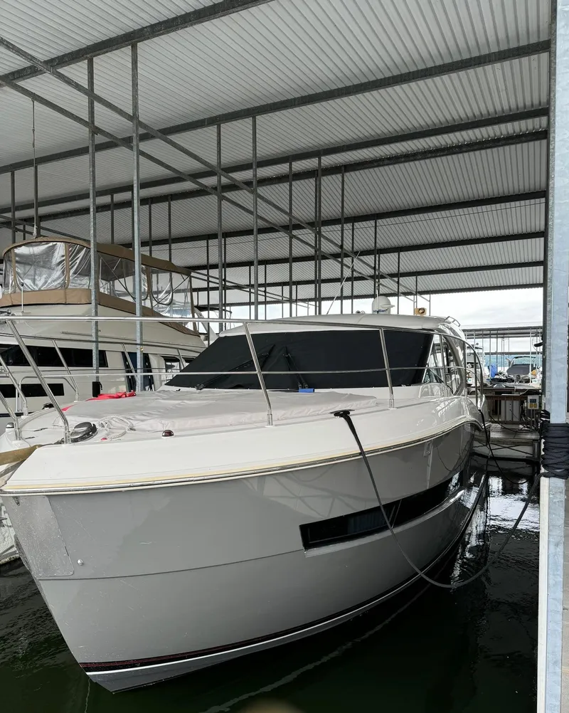 Slide: The Image of 2015 Carver C37 Coupe yacht docked in a covered marina. - 10