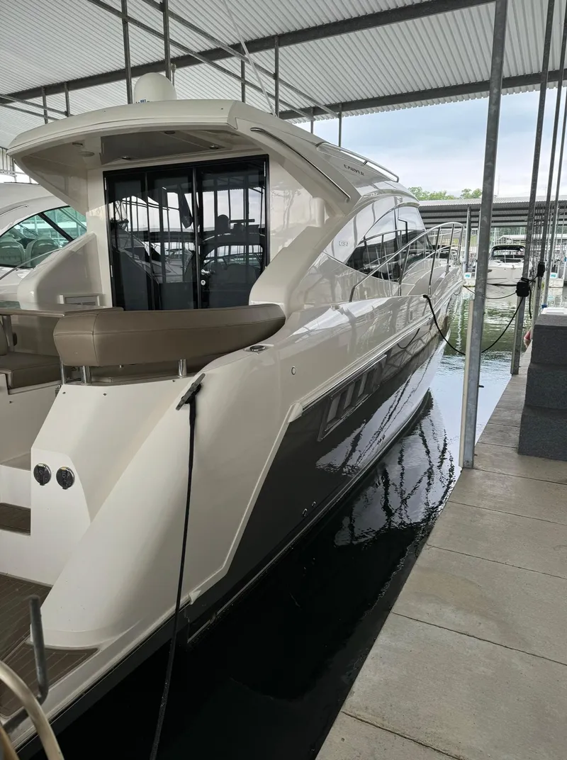 Slide: The Image of 2015 Carver C37 Coupe yacht docked in a marina. - 11
