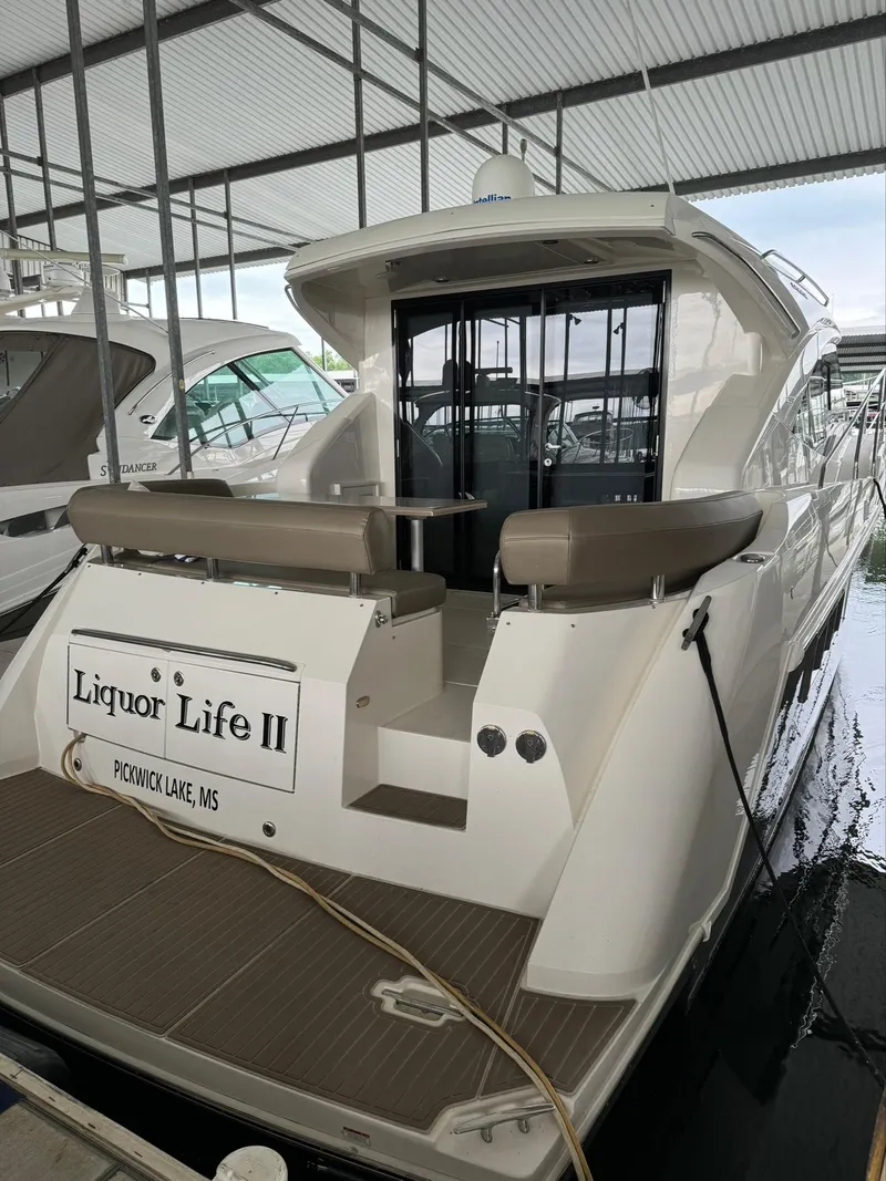 Slide: The Image of 2015 Carver C37 Coupe yacht docked, named Liquor Life II. - 12