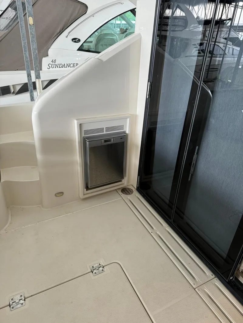 Slide: The Image of 2015 Carver C37 Coupe yacht interior with mini fridge and sliding glass door. - 14