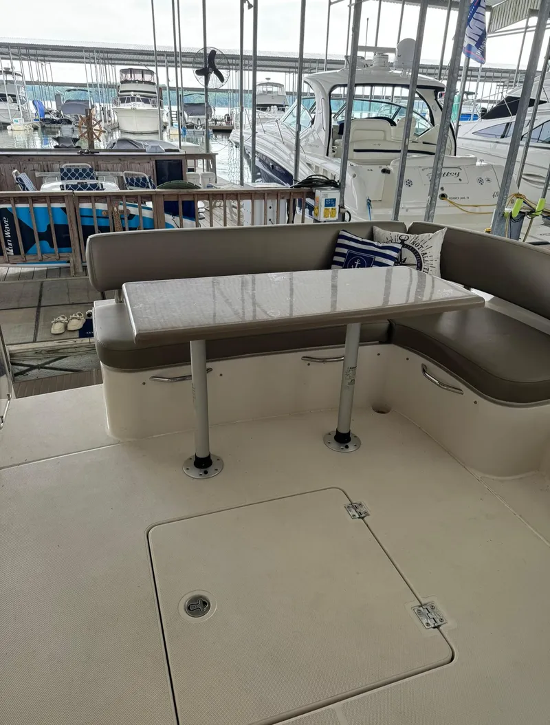 Slide: The Image of 2015 Carver C37 Coupe yacht with docked boats in the background. - 16