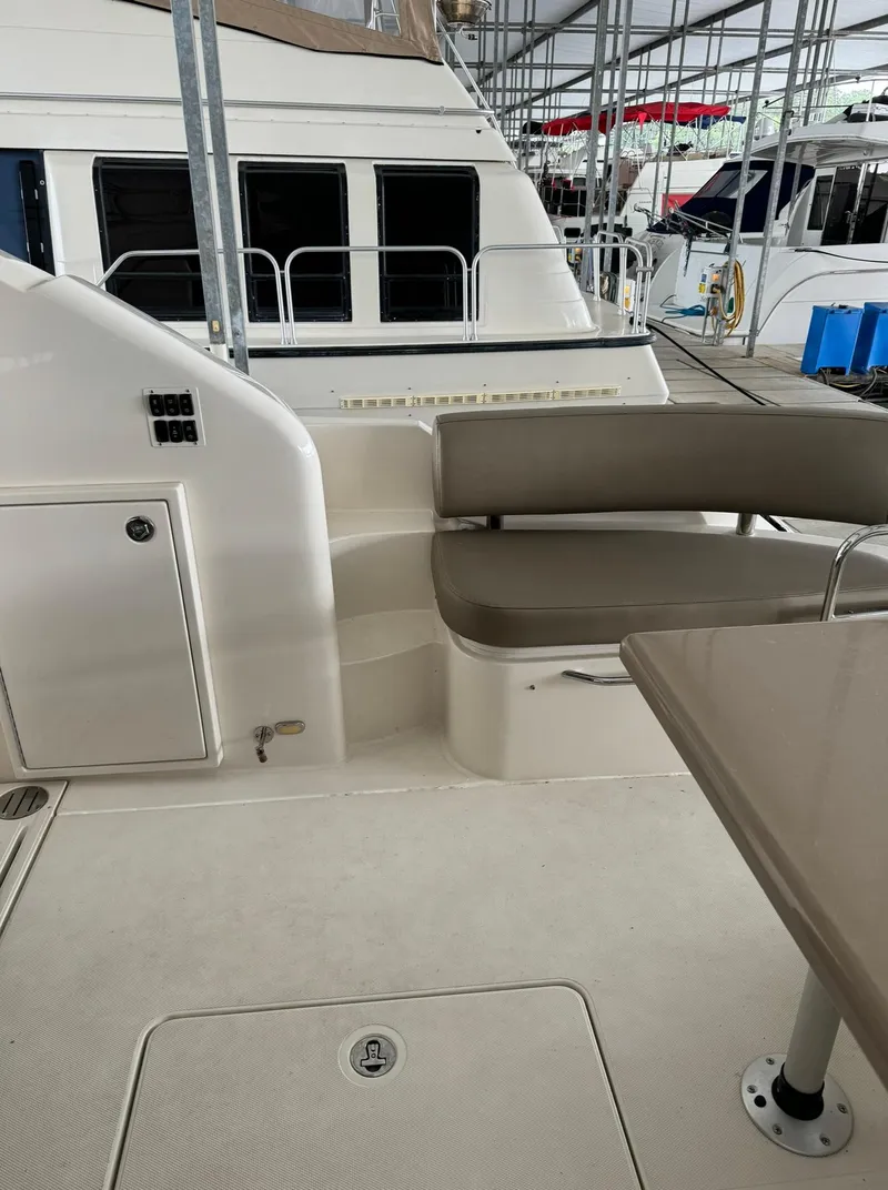 Slide: The Image of 2015 Carver C37 Coupe yacht interior with seating area and table. - 17