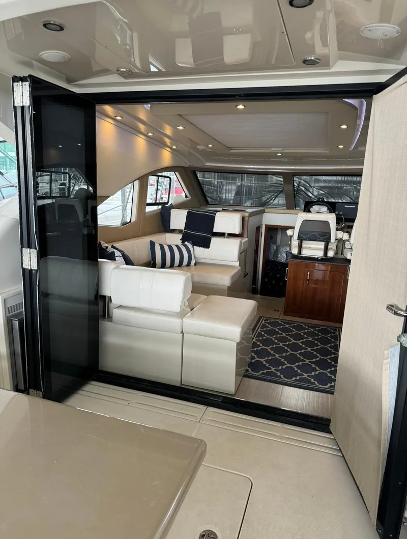 Slide: The Image of Interior of a 2015 Carver C37 Coupe yacht with modern furnishings and elegant design. - 18