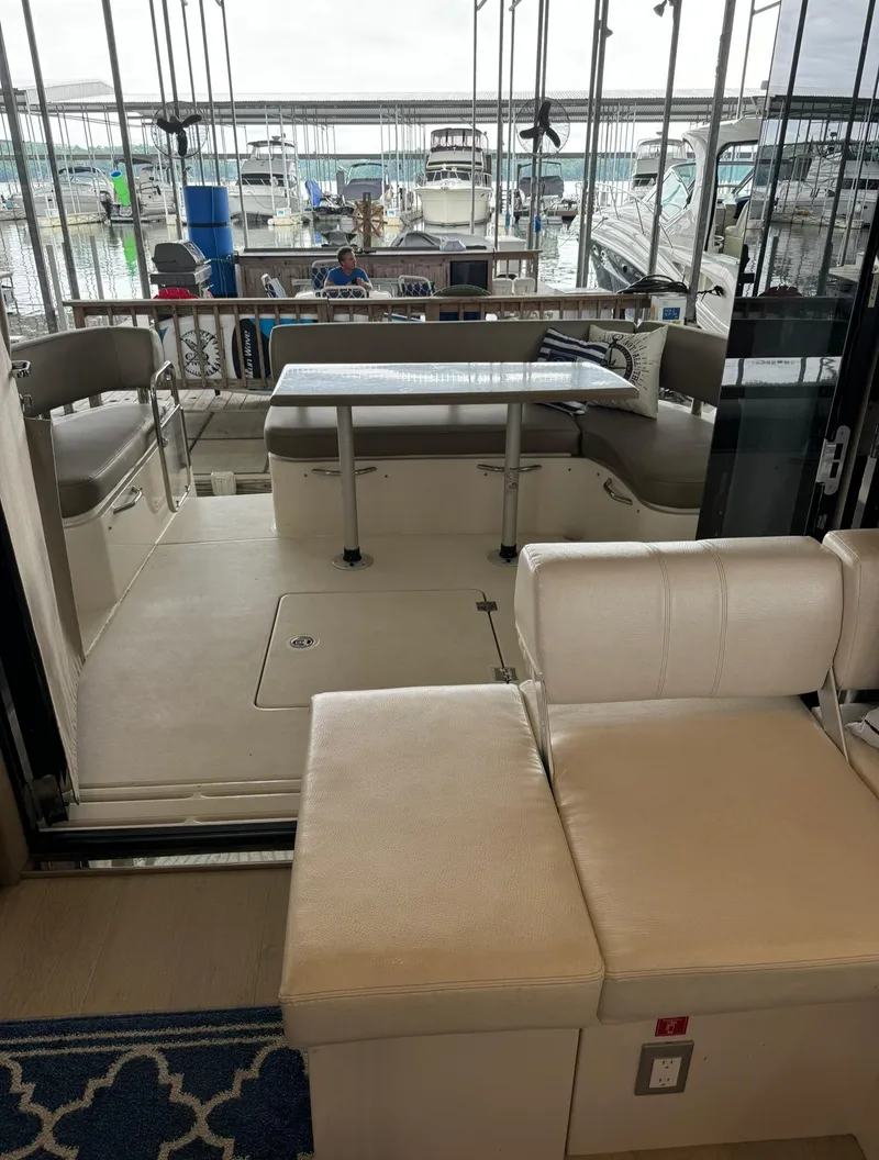 Slide: The Image of 2015 Carver C37 Coupe yacht interior with seating and table. - 19