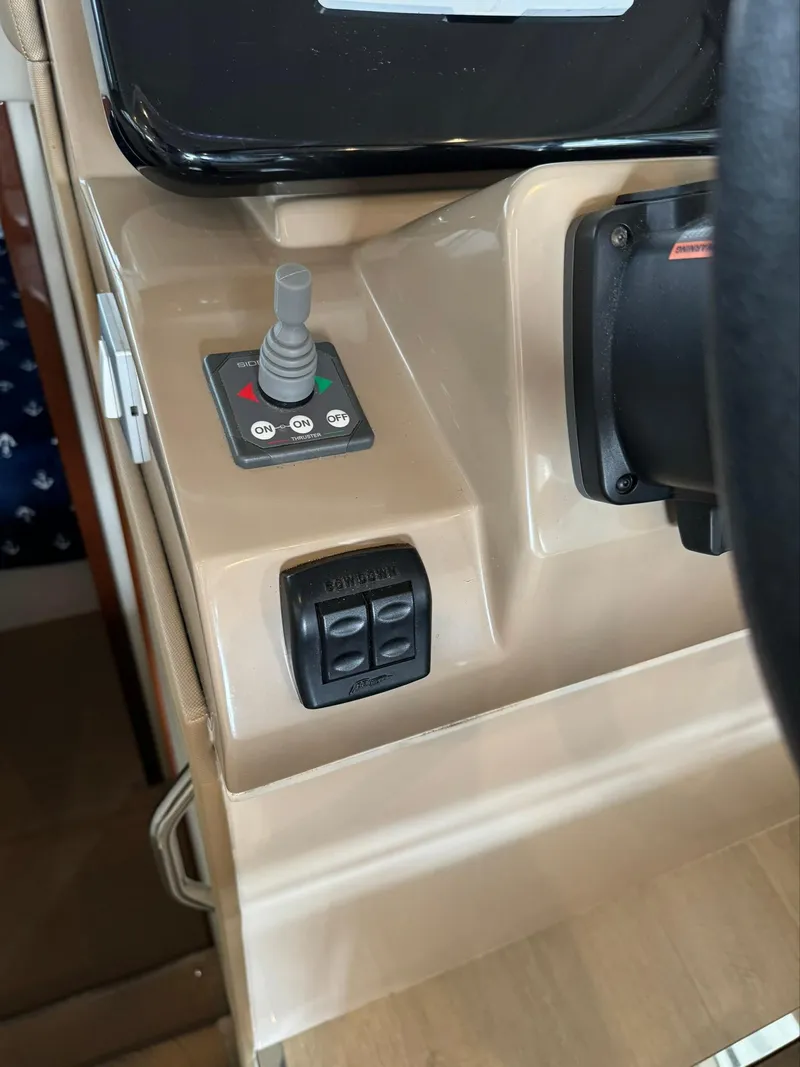 Slide: The Image of Control panel of a 2015 Carver C37 Coupe boat with joystick and switches. - 25