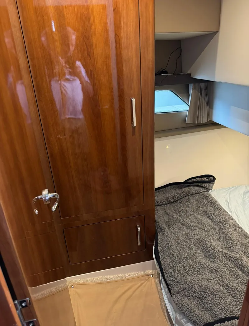 Slide: The Image of Interior cabin of a 2015 Carver C37 Coupe with wooden wardrobe and cozy bed. - 36