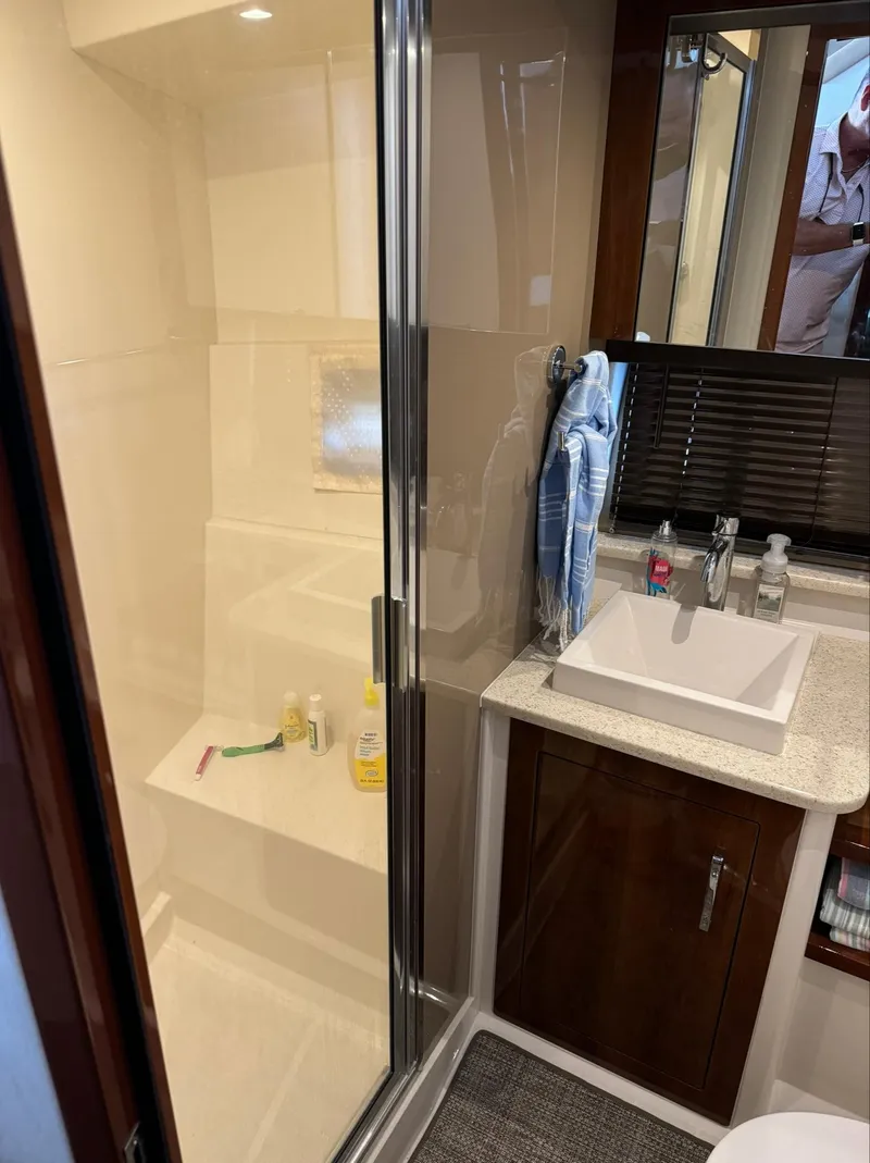 Slide: The Image of Bathroom interior of a 2015 Carver C37 Coupe with shower and sink. - 38