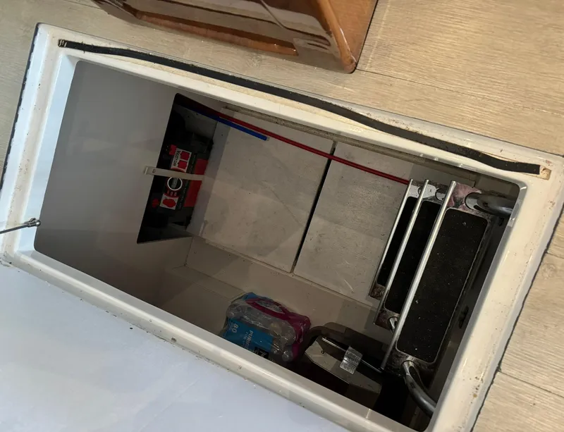 Slide: The Image of Storage compartment in 2015 Carver C37 Coupe yacht, featuring steps and utility access. - 40