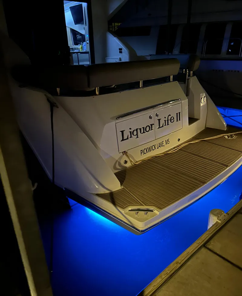Slide: The Image of 2015 Carver C37 Coupe yacht with blue underwater lights at dock. - 8