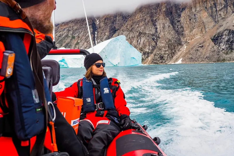 Slide: The Image of People on a Highfield Patrol 500 boat in Arctic landscape. - 1