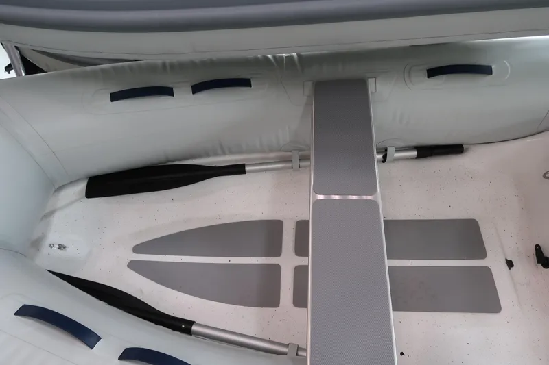 Slide: The Image of 2024 AB Inflatables Ventus 8 VL interior view with oars and seating. - 2
