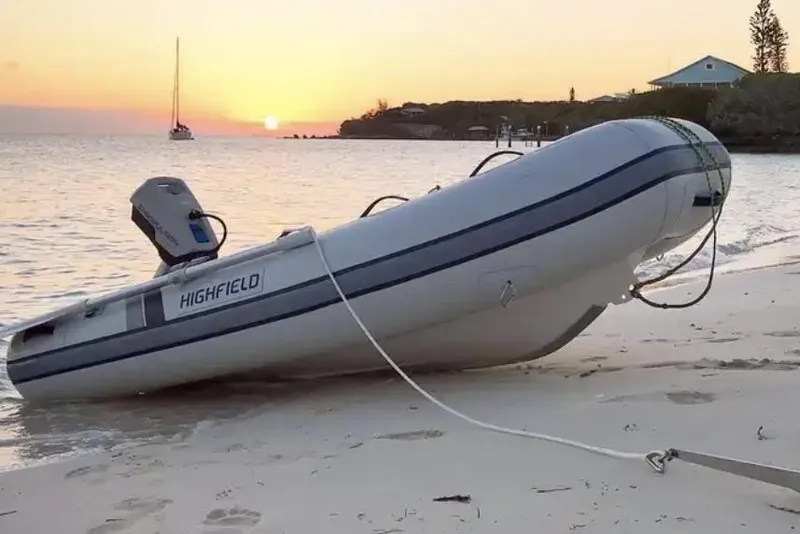 Slide: The Image of Two people on Highfield UltraLite 290LT boat, tropical setting, 2026 model. - 2