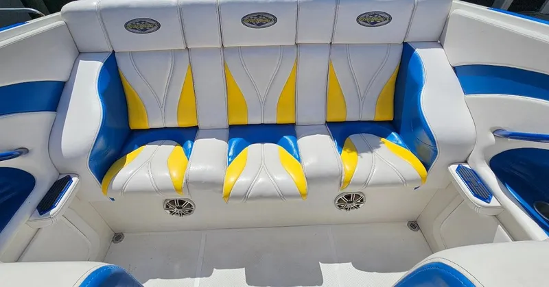 Slide: The Image of 1997 Outerlimits 37 Stiletto boat interior with blue, yellow, and white seating. - 4