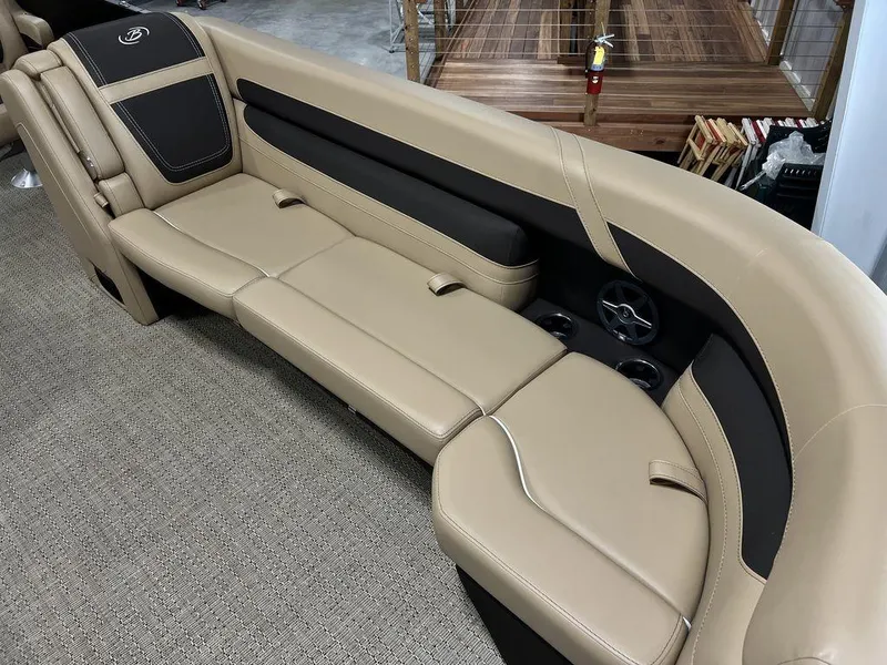 Slide: The Image of 2025 Barletta Cabrio C24UC boat interior seating with beige and black upholstery. - 11