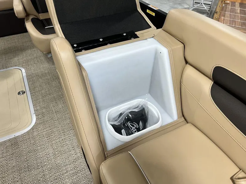 Slide: The Image of Barletta Cabrio C24UC 2025 boat interior with beige seating and built-in storage compartment. - 12
