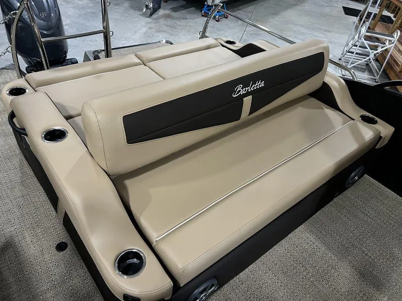 Slide: The Image of 2025 Barletta Cabrio C24UC boat with beige leather seating and cup holders. - 17