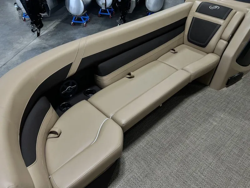 Slide: The Image of 2025 Barletta Cabrio C24UC boat interior with beige and black seating. - 2