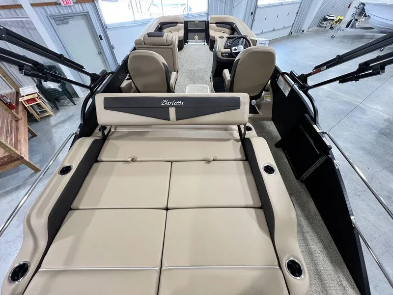 Slide: The Image of 2025 Barletta Cabrio C24UC pontoon boat interior with beige seating and modern design. - 32