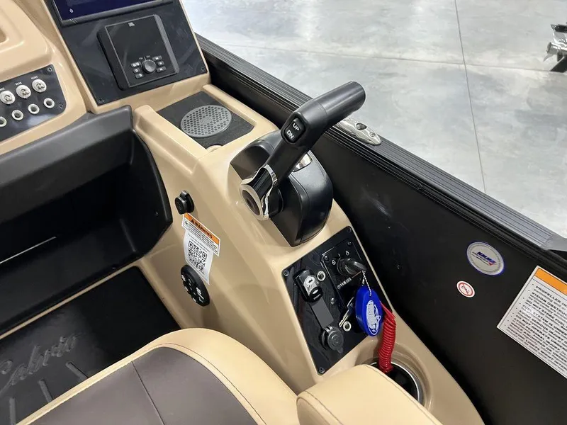 Slide: The Image of 2025 Barletta Cabrio C24UC boat control panel with throttle and navigation instruments. - 33