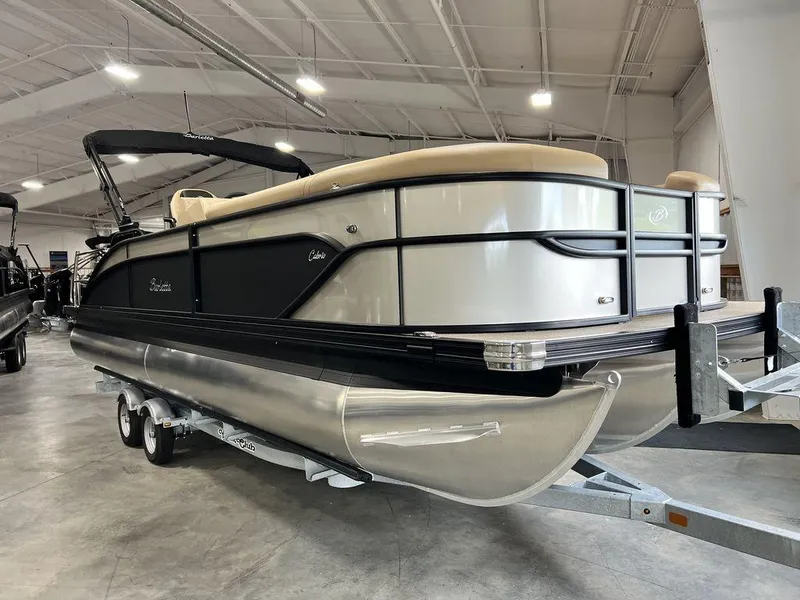 Slide: The Image of 2025 Barletta Cabrio C24UC pontoon boat in showroom on trailer. - 7