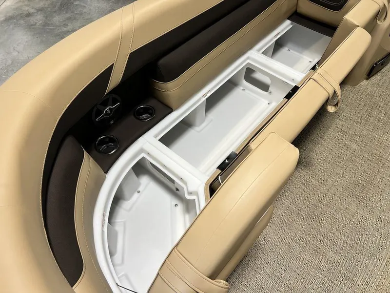 Slide: The Image of Barletta CABRIO C24UC 2025 boat interior storage compartment with beige and brown seating. - 8