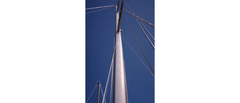 Slide: The Image of Tall mast of 1980 Sceptre 36 Athena sailboat against clear blue sky. - 12
