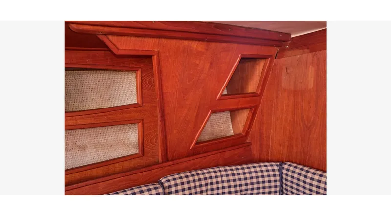 Slide: The Image of Interior of 1980 Sceptre 36 Athena yacht with wooden paneling and checkered seating. - 22