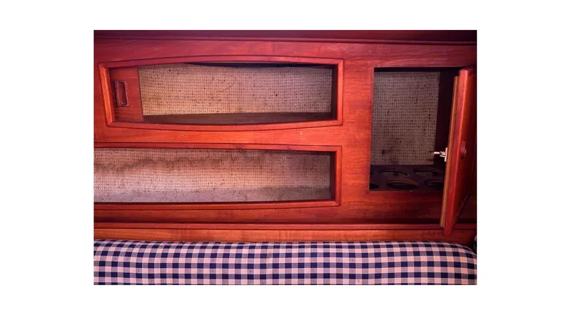 Slide: The Image of Wooden interior of 1980 Sceptre 36 Athena with checkered upholstery and open cabinet. - 27