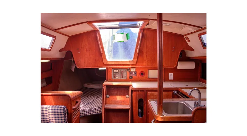 Slide: The Image of Interior of 1980 Sceptre 36 Athena sailboat with wood finish and compact kitchen. - 3