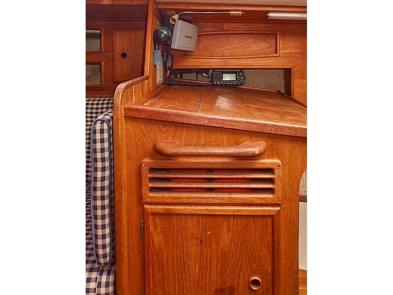 Slide: The Image of Interior of 1980 Sceptre 36 Athena sailboat with wooden cabinetry and checkered upholstery. - 33